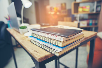 Laptop Computer for study for exam, book place on School table for student work online at home. Desktop laptop, notebook, book cup of coffee place on wooden desk. Desk for student concept