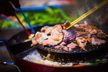 "Moo-Grata" is Thai barbecue or Korean barbecue in Thai style. It is the popular food in Asia by grill the pork, meat or sea food on the hot pan that can put the soup of vegetable around a pan too.