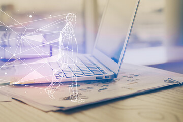 Desktop computer background in office and start up theme hologram drawing. Double exposure. Startup...
