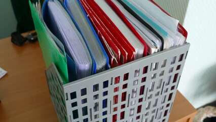 on the table in the tray folders with papers
