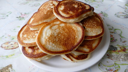 small pancakes are piled on a plate