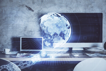 Multi exposure of table with computer and world map hologram. International data network concept.