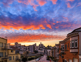 Fototapeta na wymiar High angle view of homes on the famous crooked Lombard Street, San Francisco California with fiery skies at sunset