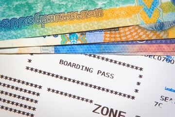 Aircraft boarding pass and asian money. Tourism, vacation, business travel concept.