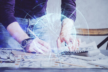 Double exposure of Man writing in notepad with business icons on background.