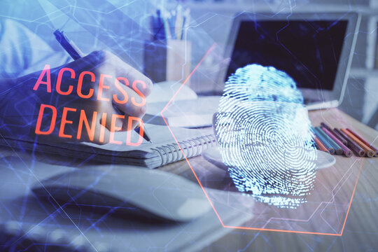 Blue fingerprint hologram over hands taking notes background. Concept of security. Double exposure