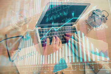 Multi exposure of forex graph with man working on computer on background. Concept of market analysis.