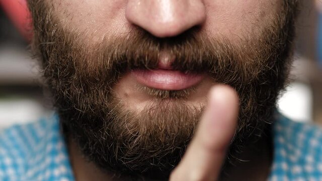Bearded man says no. Guy swings her finger from side to side showing her disagreement
