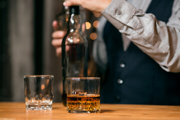 Whisky is poured into glass