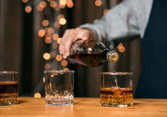 Barman pouring whiskey whiskey glass beautiful night