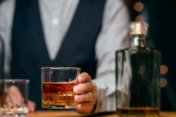 Barman pouring whiskey glass customers sit drink