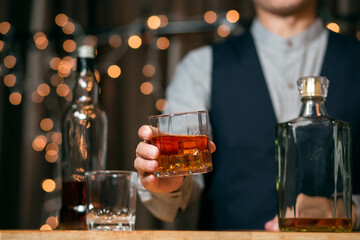 Barman pouring whiskey glass beautiful night