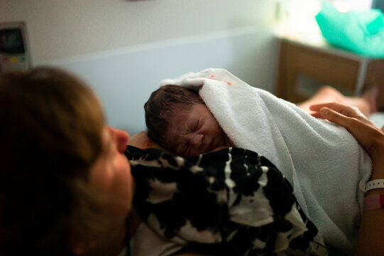 Young mother with her newborn child in the hospital