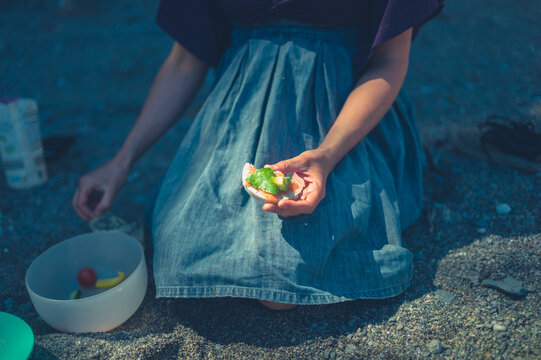 Young woman having a picnic on the beach