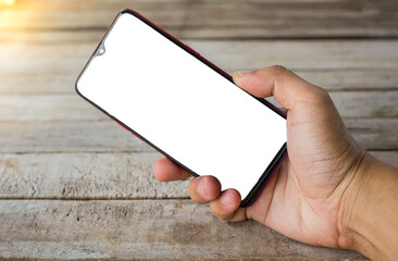 Hand hold smartphone on wood background.