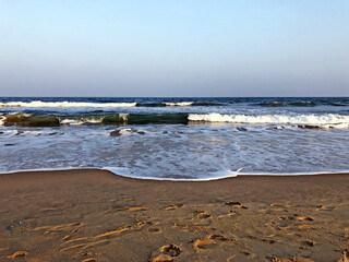 Sea waves on the shoreline of the beach in Mahabalipuram, Tamil nadu