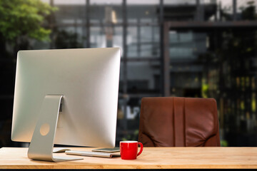 Computer Monitor, Keyboard, coffee cup smartphone, tablet, and Mouse with Blank or White Screen Isolated is on the work table in the coffeeshop .