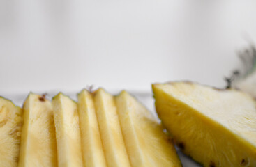 Closeup of freshly halved and sliced juicy pineapple. Organic superfood concept for healthy eating