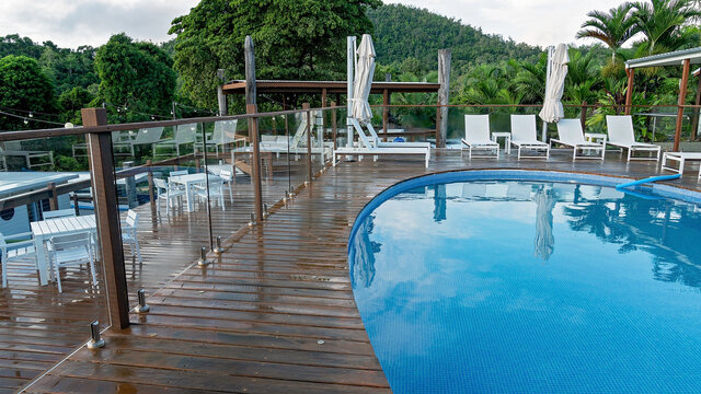 Airlie Beach, Queensland, Australia - March 2020: Pool and deck area for casual dining and swimming at a resort after rain
