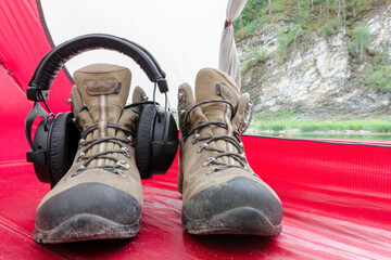 Hiking life with music. Headphones on a tracking shoe in the tent.