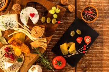 Cheese board - various types of cheese composition. Mix cheese on wooden board with grapes. Preparing healthy food. Dairy products.