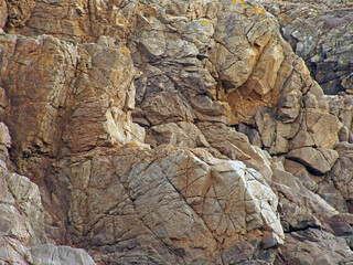 Raw rocks natural material with textured details. The main colors is orange but there is ocre light-orange strong-orange and grey areas. Shooted close-up in 4x3 photography