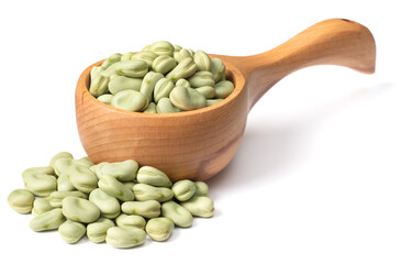 dried green broad beans in the wooden spoon, isolated on white background