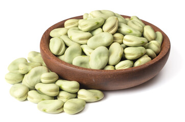 uncooked dried green faba beans in the wooden bowl, isolated on white background
