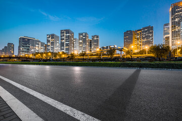 Asphalt highway and modern business district office buildings in Beijing at night, China