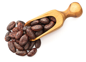 peeled cocoa beans in the wooden scoop, isolated on white background, top view