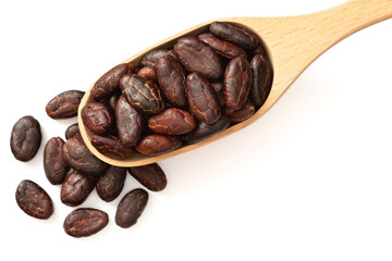 peeled cocoa beans in the wooden spoon, isolated on white background, top view