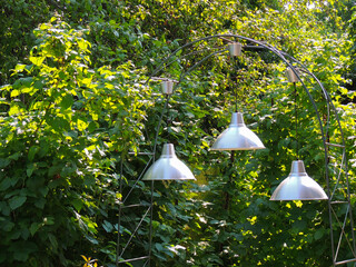 industrial aluminum lamps.background of green leaves.