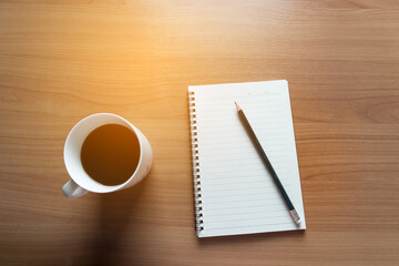 Travel Planning on Calendar and use post-it for note with a cup of coffee on a wooden table