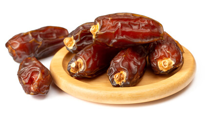 dried date palms in the wooden bowl, isolated on white background