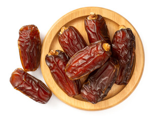dried date palms in the wooden bowl, isolated on white background, top view