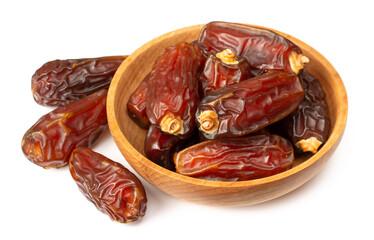 dried date palms in the wooden bowl, isolated on white background