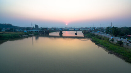 .scenery sunset above Dechatiwong bridge across Chao Phraya river in Nakornsawan province Thailand