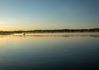 Foggy weather early in the morning on the lake. beautiful wallpapers. a mystical mist vibrates in the lake. summer sunrise