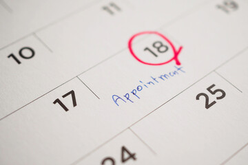 important appointment schedule write on white calendar page date close up