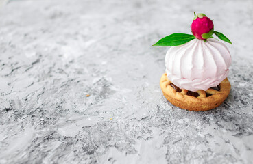 Dessert. Pink marshmallows decorated with flower. Gray background.