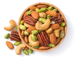 Fotobehang unsalted mixed nuts in the wooden bowl, isolated on white background, top view © Amy Lv