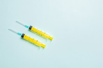 Top view of medical syringes on colorful background with copy space. Injection equipment concept