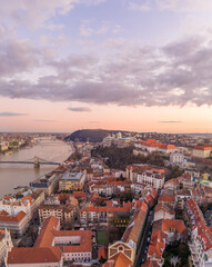 Fototapeta premium Aerial drone shot of Buda castle on hill during Budapest sunset hour