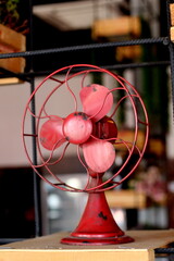 Fototapeta na wymiar Old red fan on the shelf for display