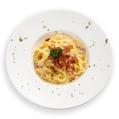 Spaghetti carbonara with bacon in white plate on white background.