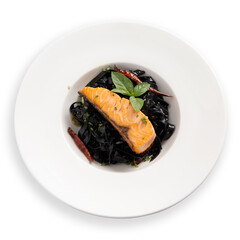 Squid ink fettuccine with grilled Salmon in white plate on white background.