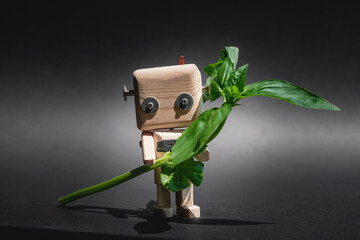wooden robot with foliage, the concept of waste recycling, environmental conservation, battery recycling. nature versus technology