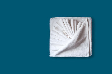 Folded white towels isolated on blue background