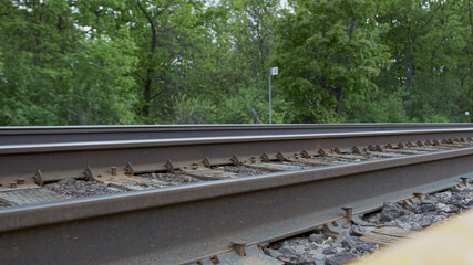 High quality closeup picture of a railway and forest close to it on a background. Empty railway.