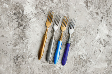 Set of 4 exclusive colored forks on a beautiful gray background